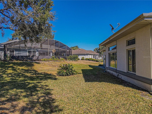 view of yard featuring glass enclosure