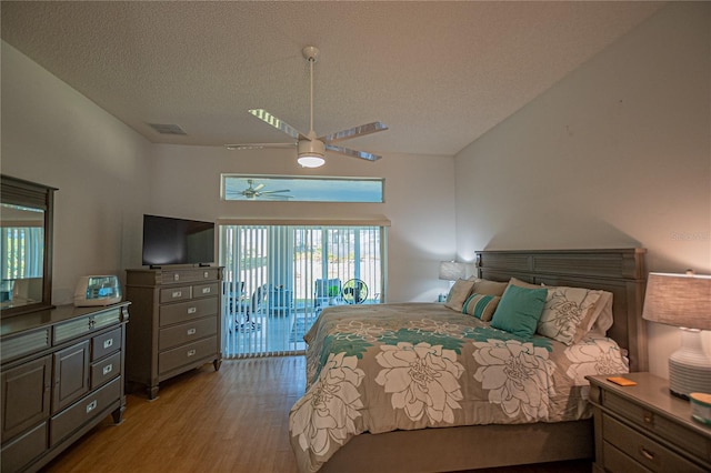 bedroom featuring lofted ceiling, access to outside, ceiling fan, a textured ceiling, and light hardwood / wood-style flooring