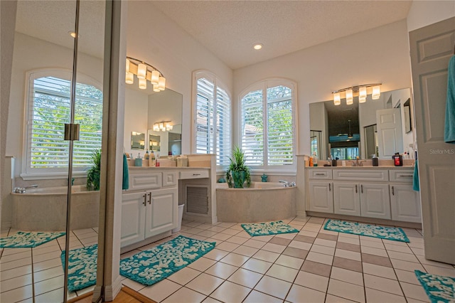 bathroom with vanity, tile patterned floors, plus walk in shower, and a textured ceiling