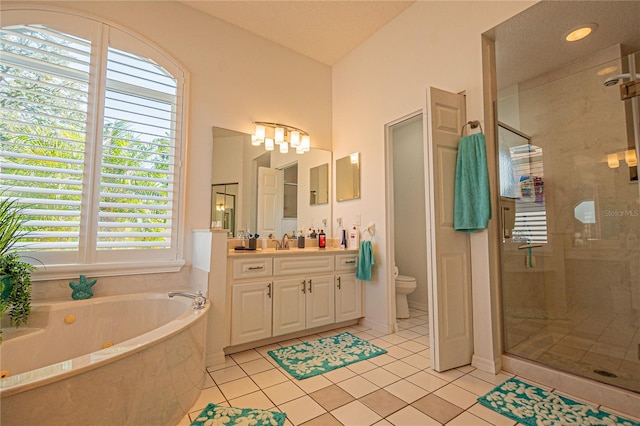 full bathroom with tile patterned flooring, vanity, toilet, and separate shower and tub