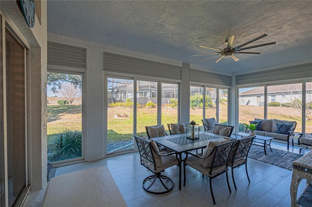 sunroom / solarium featuring ceiling fan