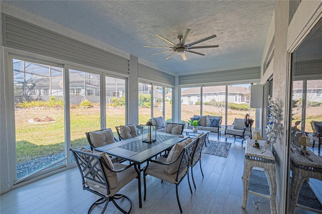 sunroom with ceiling fan