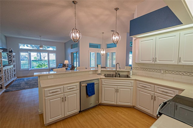 kitchen with pendant lighting, sink, electric stove, stainless steel dishwasher, and kitchen peninsula