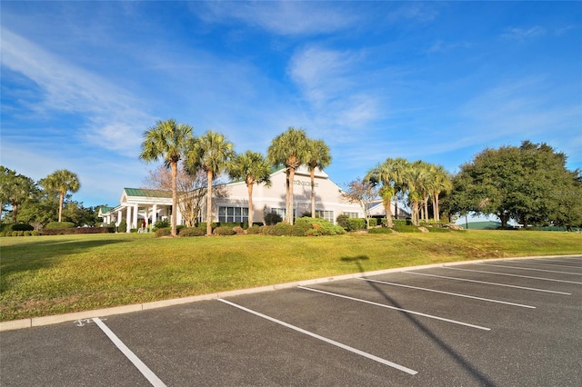 view of parking featuring a lawn