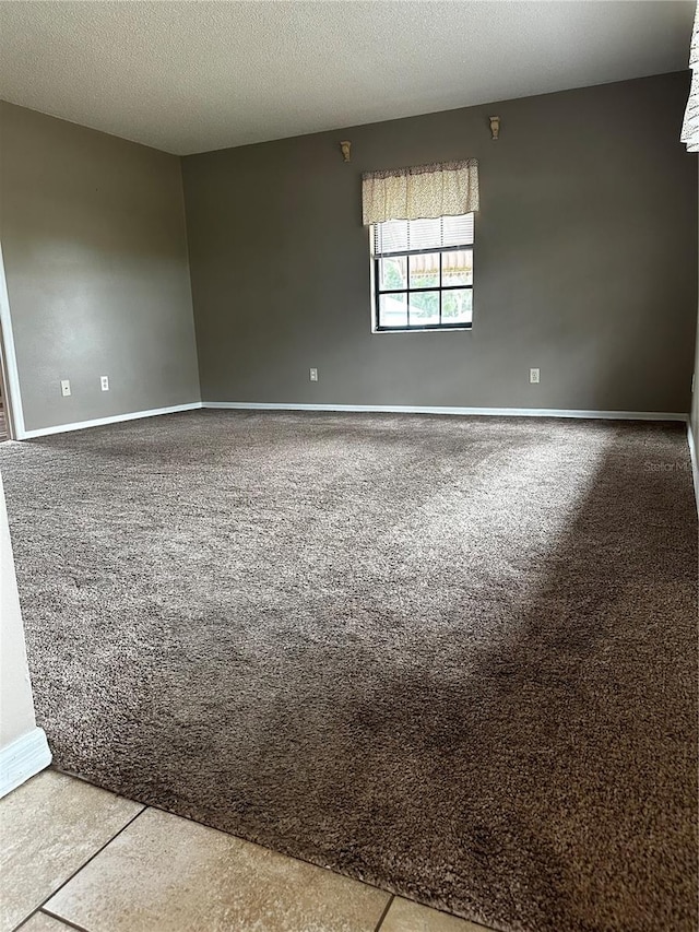 unfurnished room featuring a textured ceiling