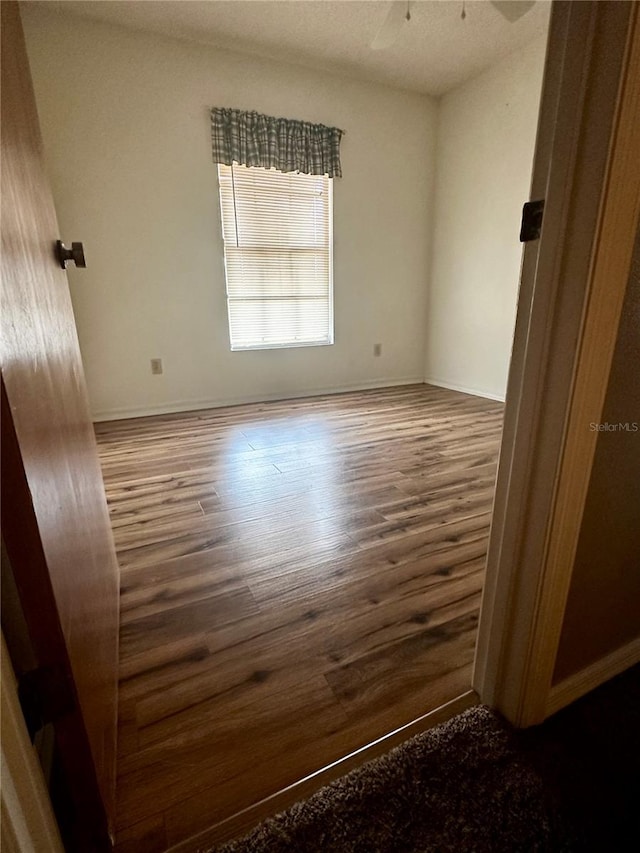 empty room featuring hardwood / wood-style flooring and ceiling fan