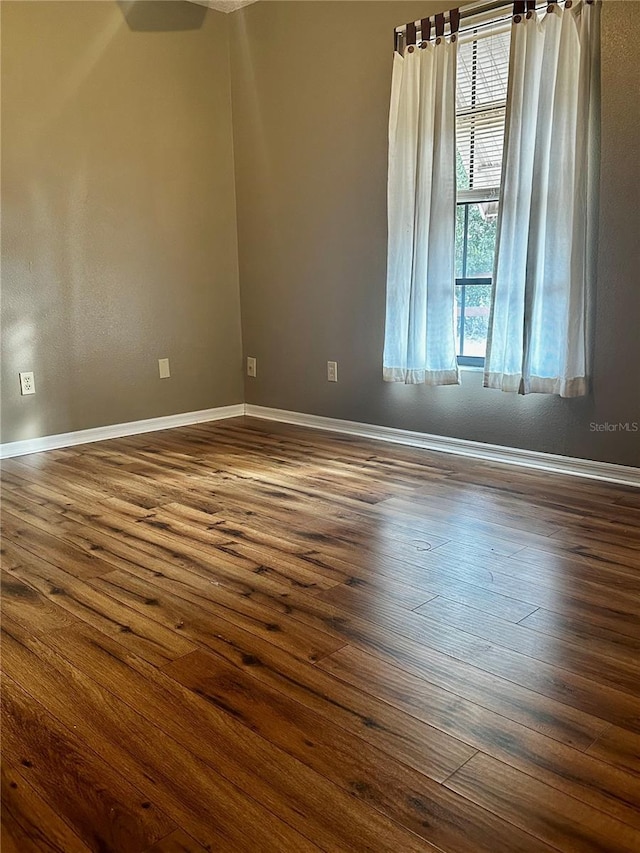 spare room featuring dark hardwood / wood-style floors