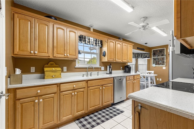 kitchen with dishwasher, sink, light tile patterned floors, ceiling fan, and a textured ceiling