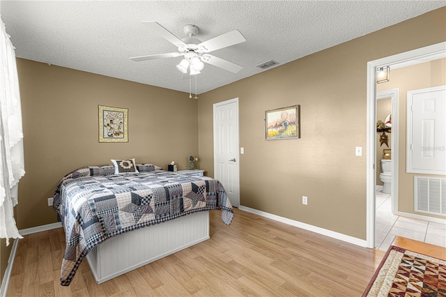 bedroom featuring ceiling fan, a textured ceiling, and light wood-type flooring