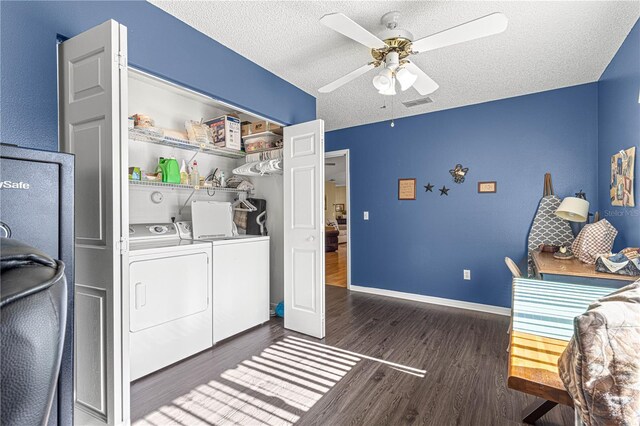 washroom with ceiling fan, dark wood-type flooring, a textured ceiling, and washer and clothes dryer