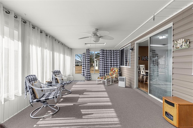 sunroom / solarium featuring ceiling fan