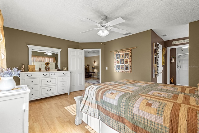 bedroom with ceiling fan, light hardwood / wood-style flooring, and a textured ceiling