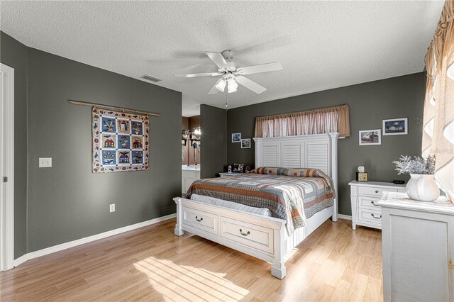 bedroom with ceiling fan, a textured ceiling, and light wood-type flooring