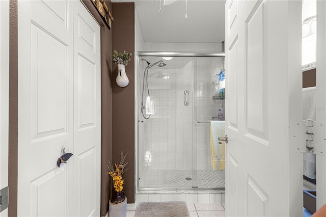 bathroom featuring tile patterned floors, a textured ceiling, and walk in shower