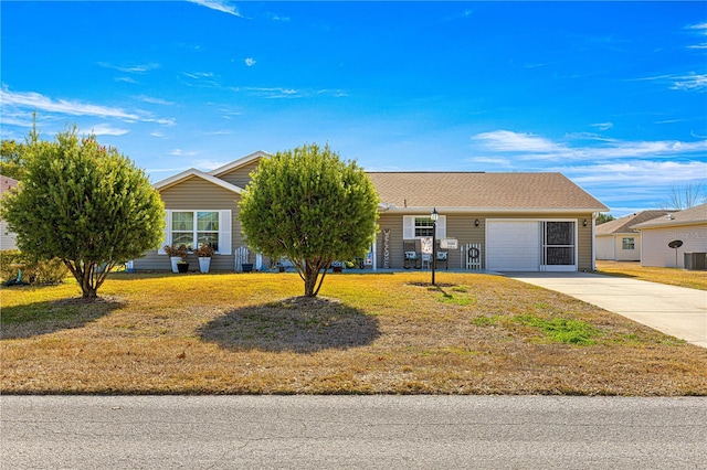 ranch-style home with a garage and a front lawn