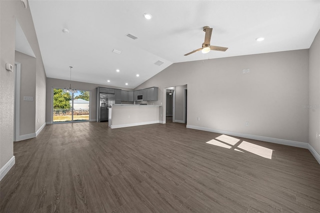 unfurnished living room featuring dark wood-type flooring, lofted ceiling, and ceiling fan with notable chandelier