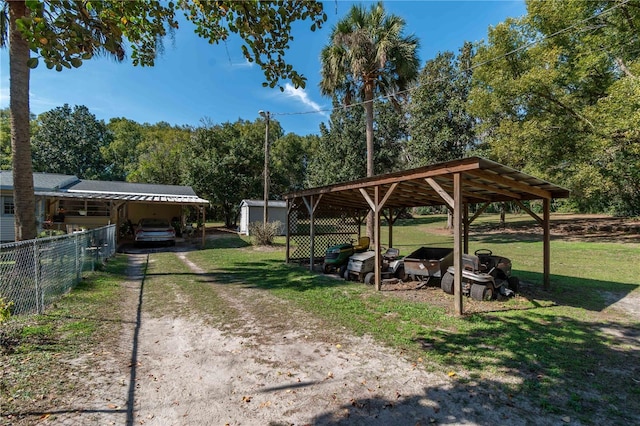 view of home's community with an outdoor structure and a lawn