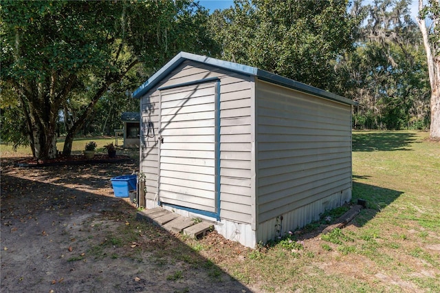 view of outdoor structure featuring a lawn