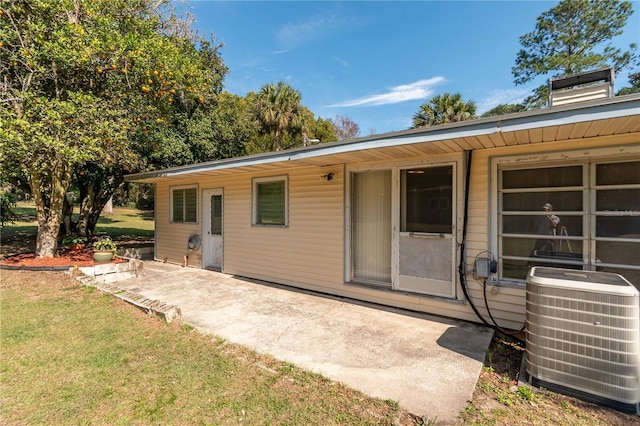 exterior space with central AC, a patio, and a lawn