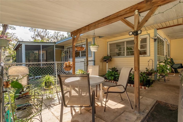 view of patio with a sunroom