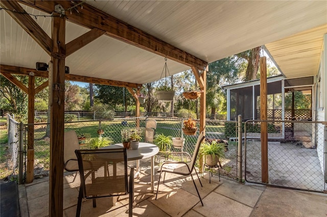 unfurnished sunroom with beamed ceiling