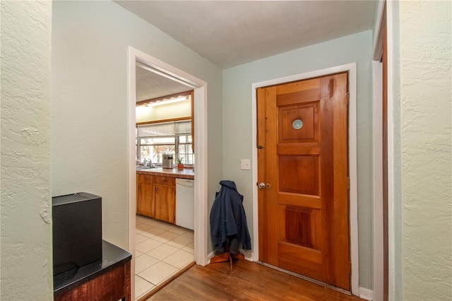 hall with sink and light hardwood / wood-style floors