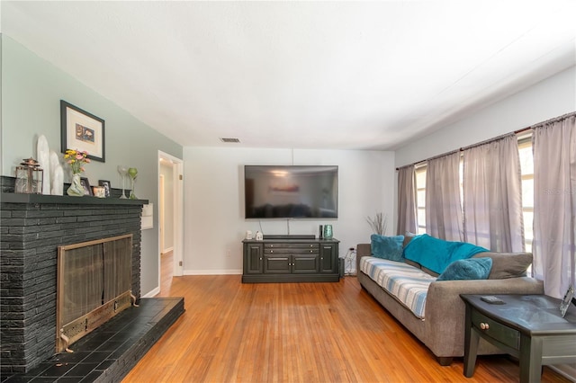 living room with a fireplace and light hardwood / wood-style flooring