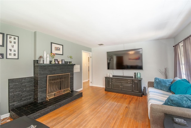 living room featuring a fireplace and light hardwood / wood-style flooring