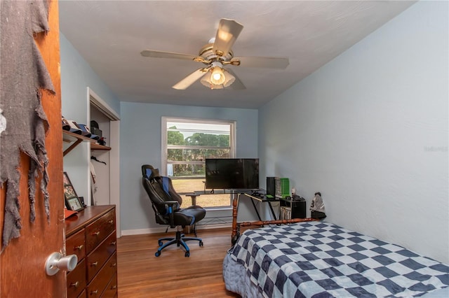 bedroom with ceiling fan and light wood-type flooring