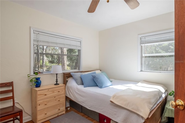 bedroom with multiple windows and ceiling fan