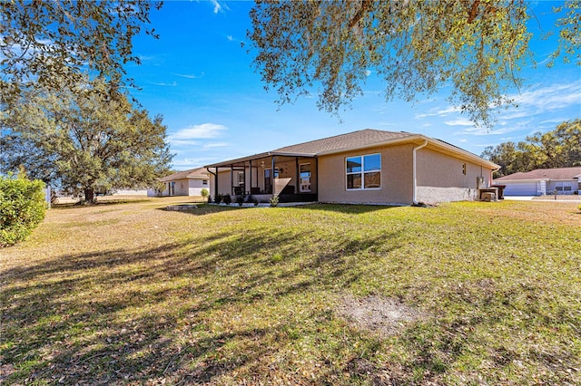 rear view of property featuring a yard