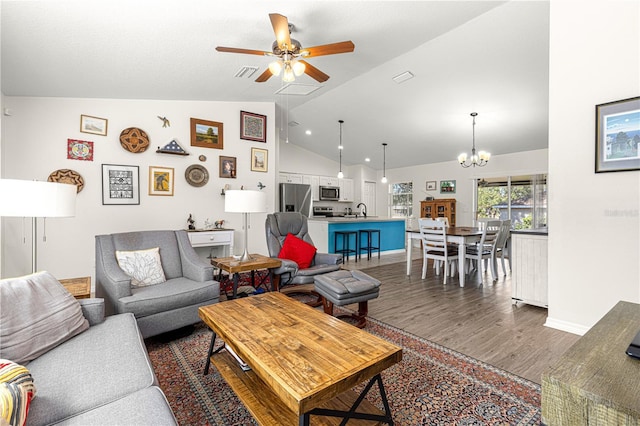 living room with sink, ceiling fan with notable chandelier, dark wood-type flooring, and high vaulted ceiling