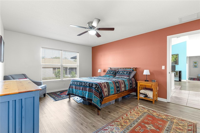 bedroom featuring dark hardwood / wood-style flooring and ceiling fan