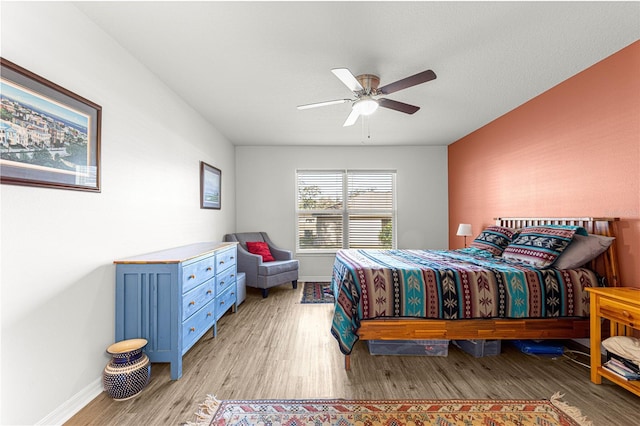 bedroom with ceiling fan and light hardwood / wood-style floors