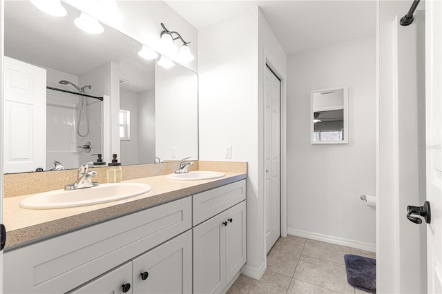 bathroom featuring walk in shower, vanity, and tile patterned flooring