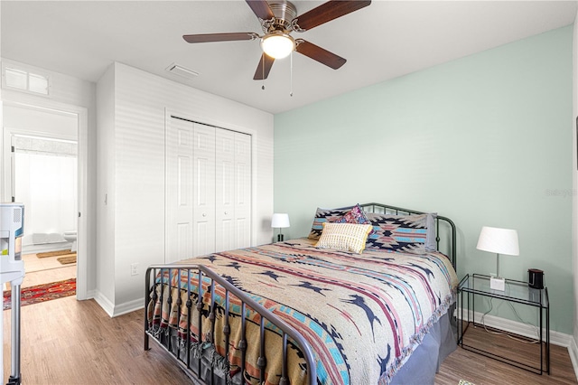 bedroom with ceiling fan, wood-type flooring, and a closet