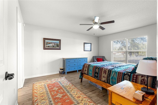 bedroom with ceiling fan, a textured ceiling, and light wood-type flooring