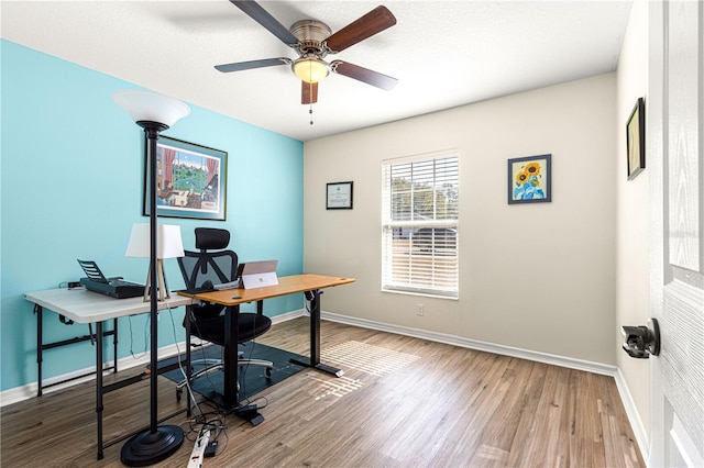 home office with hardwood / wood-style floors, a textured ceiling, and ceiling fan