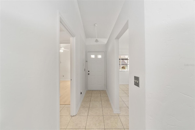 hall with light tile patterned floors