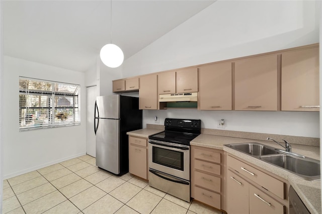 kitchen with vaulted ceiling, pendant lighting, light brown cabinetry, sink, and stainless steel appliances