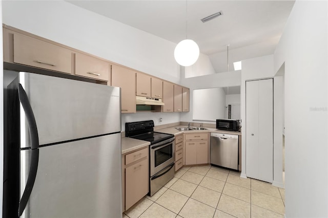 kitchen with pendant lighting, light tile patterned floors, sink, stainless steel appliances, and light brown cabinetry