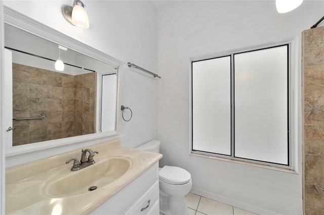 bathroom featuring tile patterned floors, vanity, and toilet