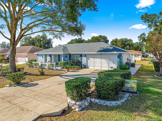 ranch-style home with a garage, a front yard, and covered porch