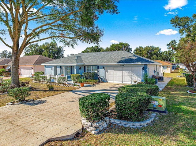 ranch-style home with a garage, covered porch, and a front yard