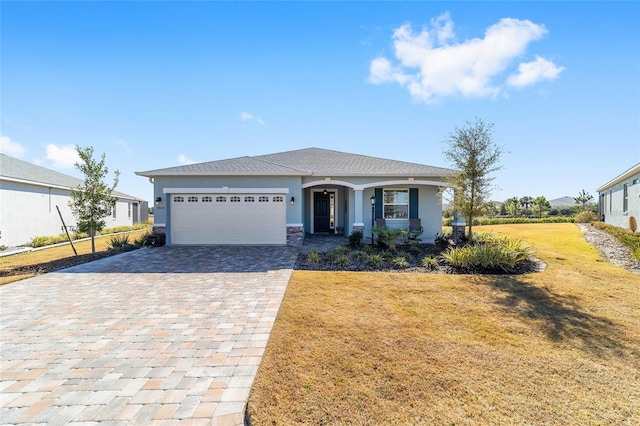 view of front of property with a garage and a front yard