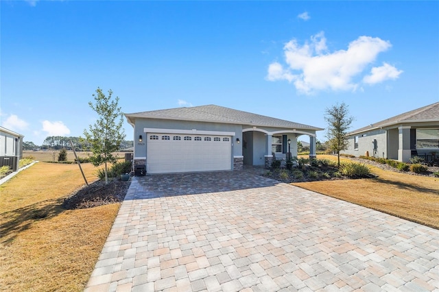 view of front of home with a garage and a front lawn