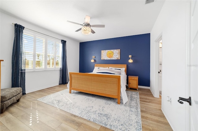 bedroom with ceiling fan and light hardwood / wood-style flooring