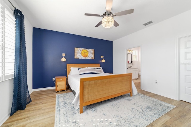 bedroom featuring ceiling fan, connected bathroom, and light hardwood / wood-style floors