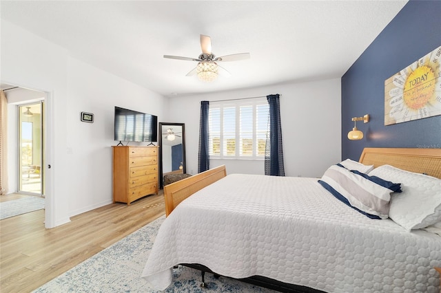 bedroom with ceiling fan and light hardwood / wood-style floors