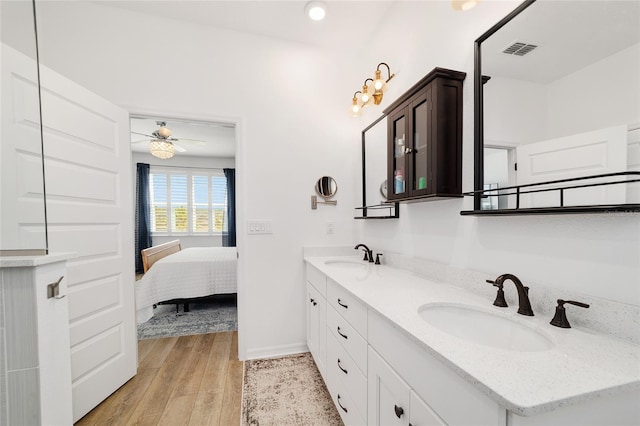 bathroom with vanity, hardwood / wood-style floors, and ceiling fan